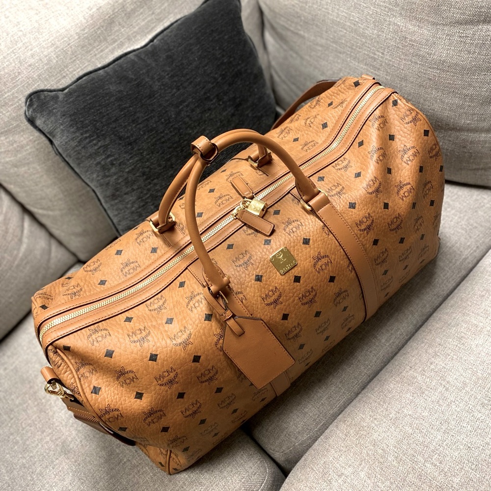 This is a beige/tan/brown McM duffel bag. Unisex! Large bag.